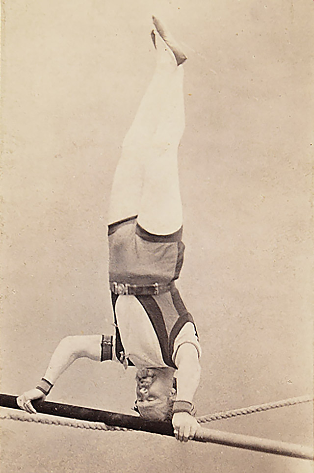 Blondin performing a headstand. Studio photograph by Fratelli Alinari.